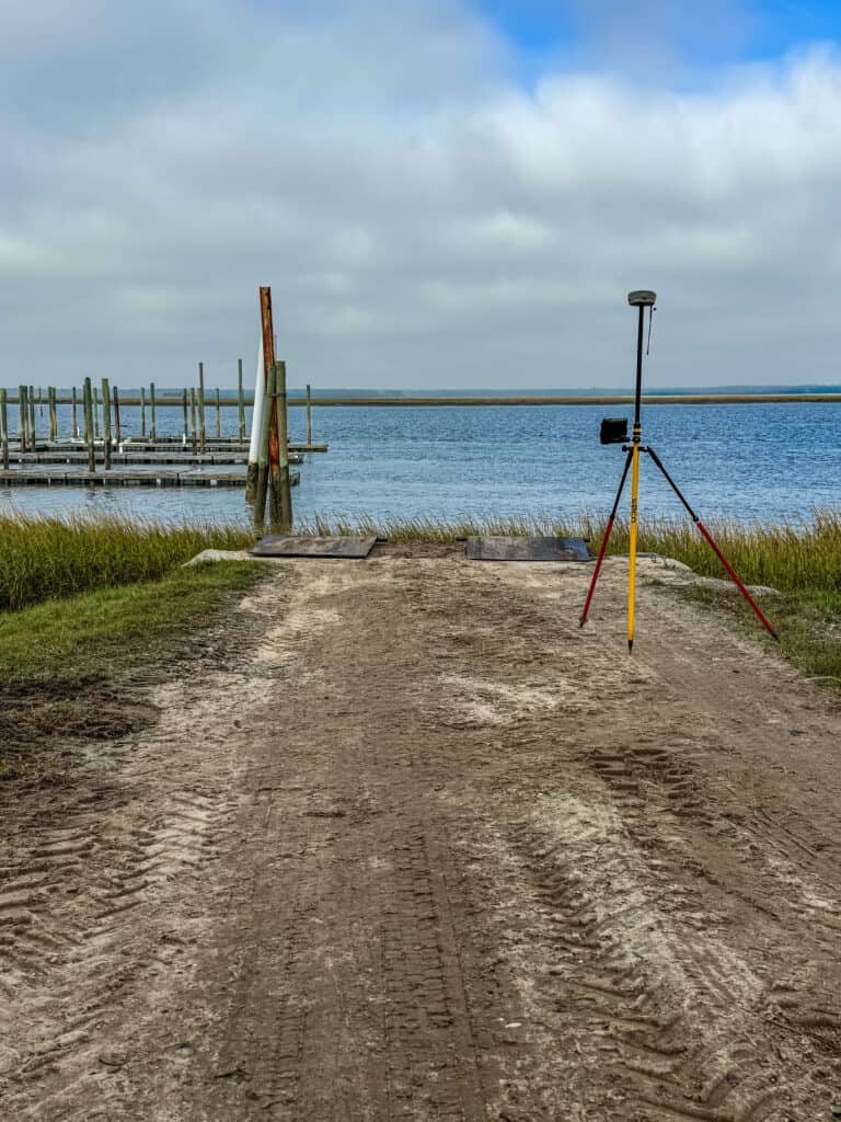 Surveying equipment set up for coastal and waterfront surveying near a dock in the South Carolina Lowcountry